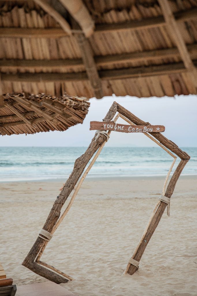 YOU & ME Casa Bay driftwood sign on the beach